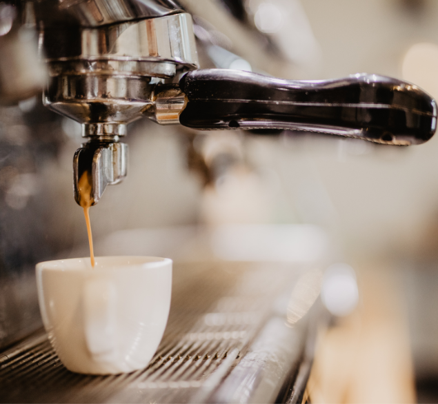 Commercial coffee machine pouring espresso shot